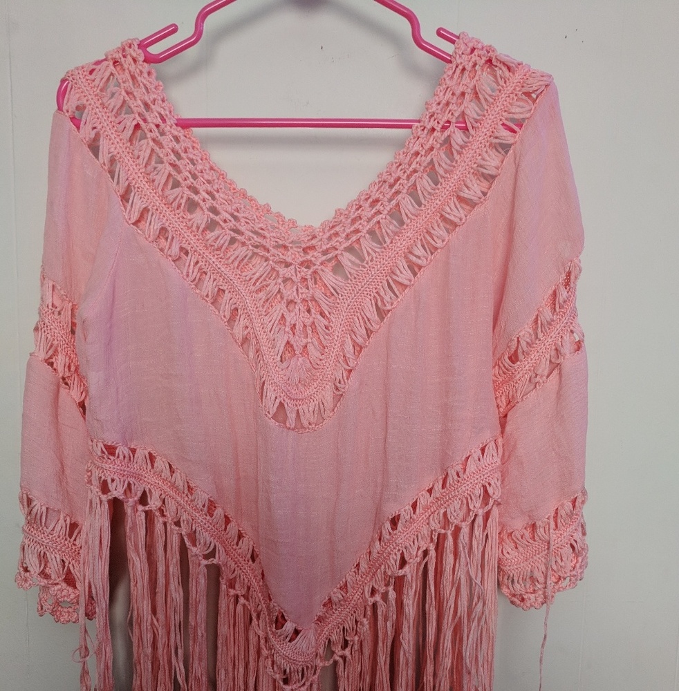 Pink fringed poncho
